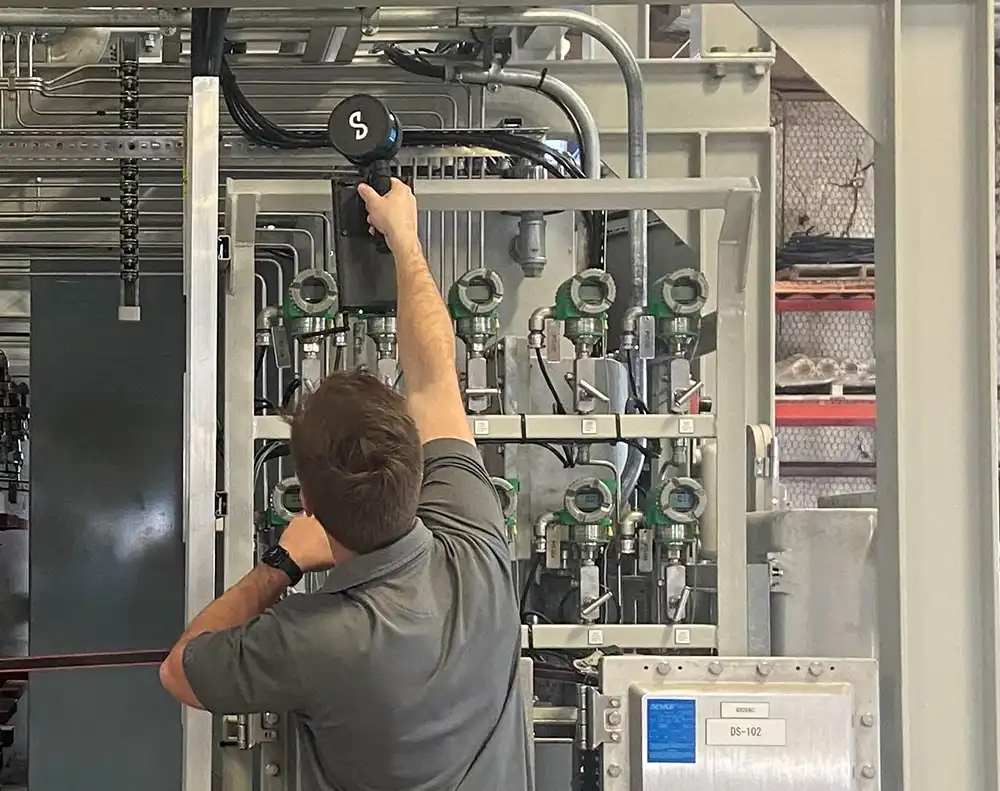 Engineer inspecting industrial equipment during on-site evaluation