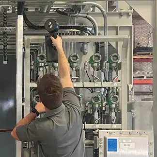 Engineer inspecting industrial equipment during on-site evaluation