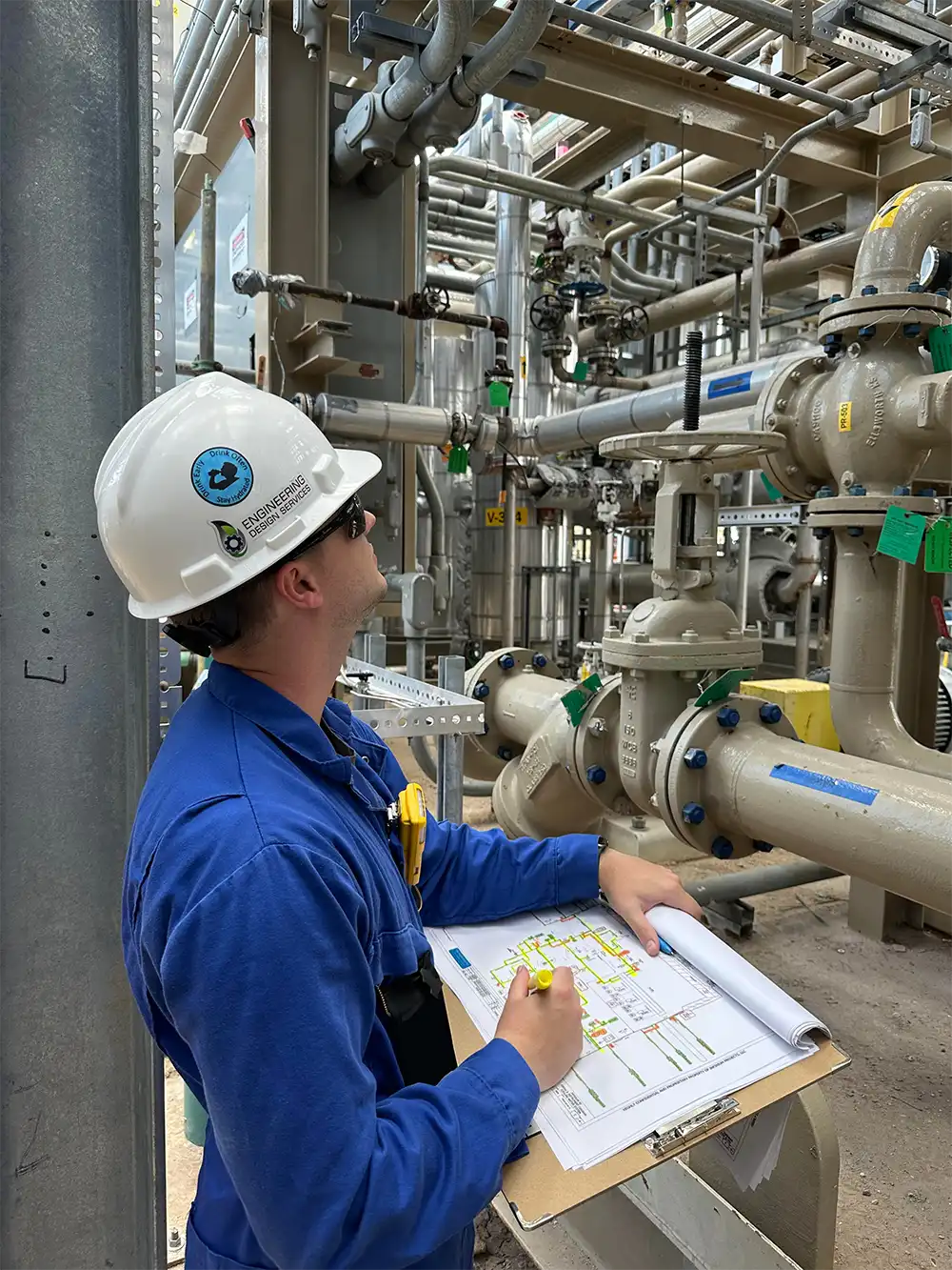 Engineer inspecting industrial equipment for recurring engineering.