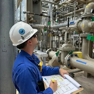 Engineer performing on-site inspection of industrial systems and equipment