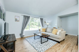 couch and coffee table across from TV