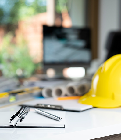 Construction industry bookkeeping cleanup — hard hat, notebook, and pen representing job site financial recordkeeping