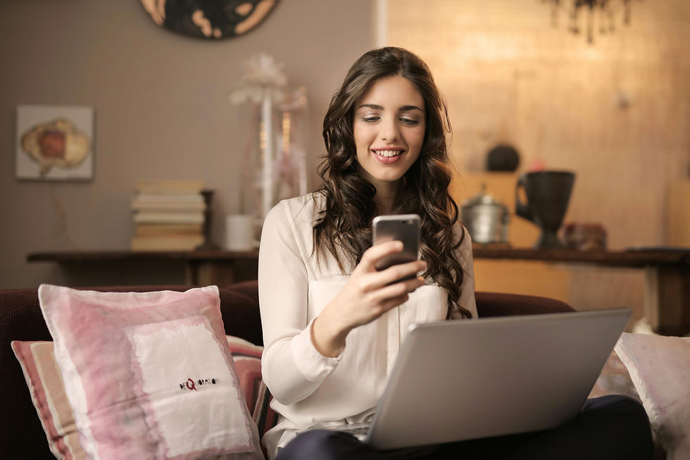 Woman relaxed on sofa with laptop, representing how easy it is to book a free hypnotherapy consultation online