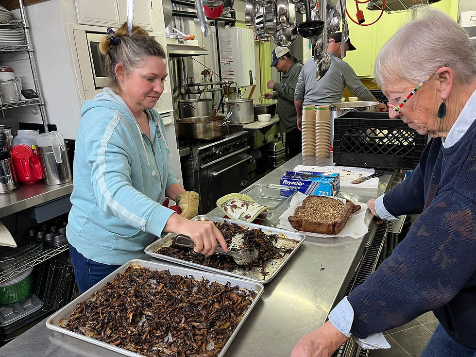 scene in a commercial kitchen and two women preparing roasted mushrooms.