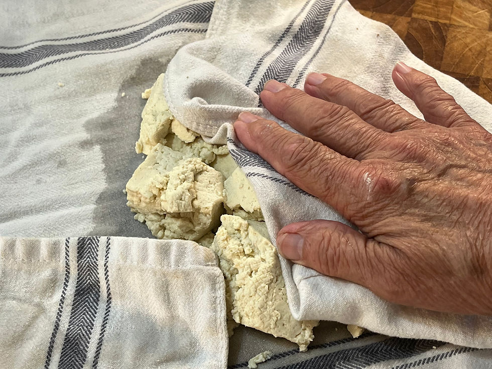 pressing the surface moisture from the boiled tofu