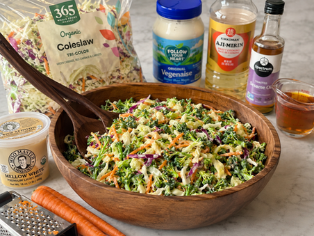 a large wood salad bowl with miso coleslaw surrounded by the ingredients