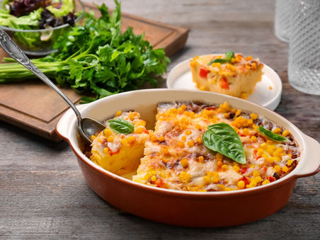 A casserole dish filled with freshly baked corn pudding