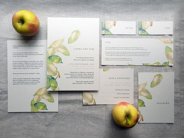 Apple Leaves - Apple Leaves - flatlay with wedding invitations, table names, place names, save the dates and menu