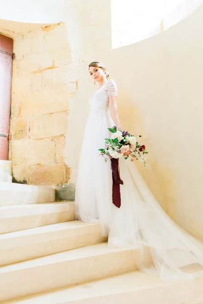 Bride on the stairs - 5 star Hilltop chateau wedding venue in the Dordogne