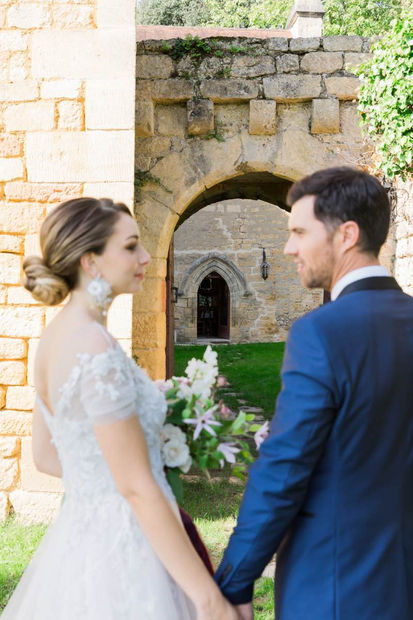 Couple in front of an arch - 5 star Hilltop chateau wedding venue in the Dordogne