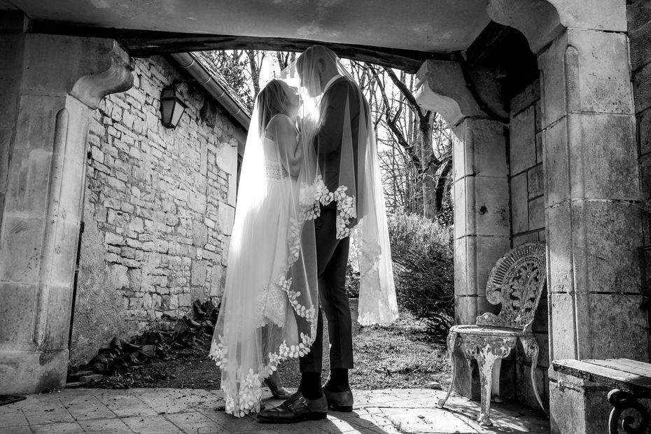Bride and groom under the veil - Riverside castle wedding venue in ancient parkland in central France.