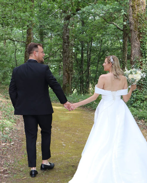 Bride and groom woodland walk Saint Emilion 16th century Chateau wedding venue in France