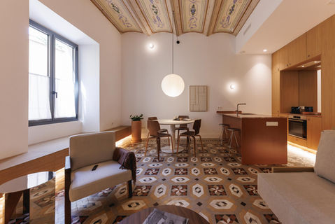 Modern apartment living room with patterned floor and ornate ceiling