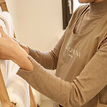 A close cropped view of arms hanging a towel