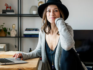 social media manager sitting at her desk with laptop