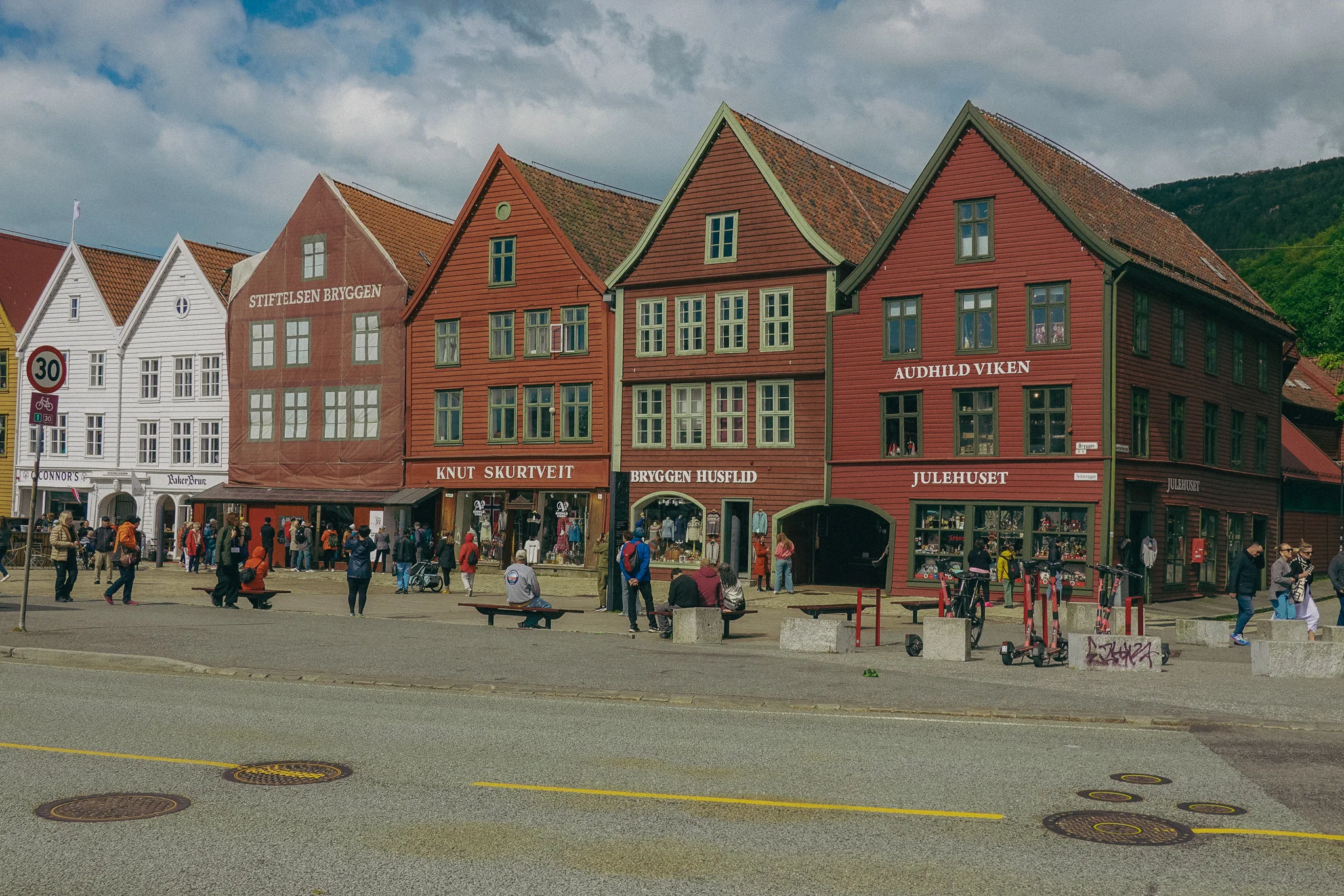 A row of colorful old buildings and shops with shingle roofs in Bergen Norway