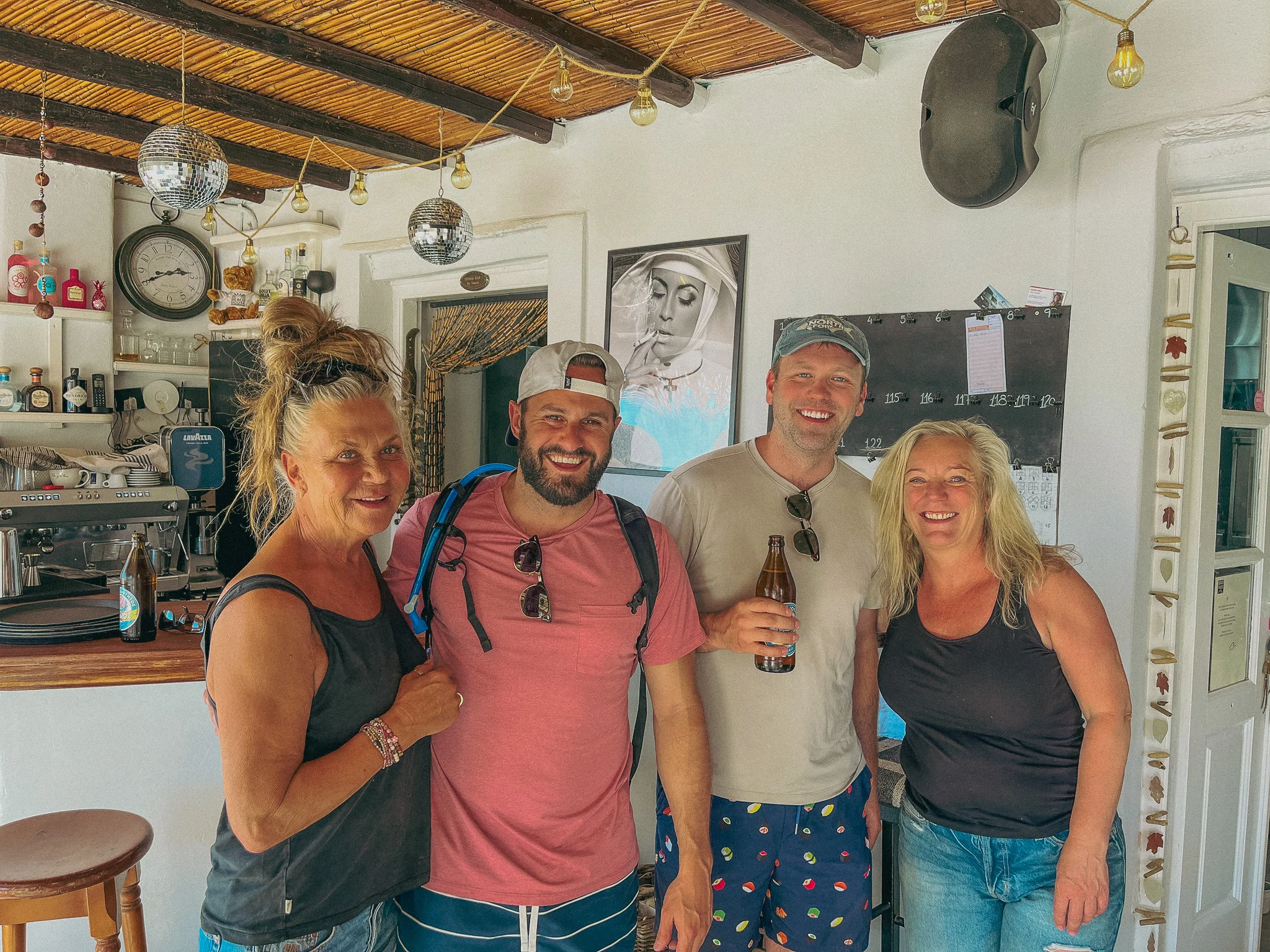 Two men pose with two women inside Beach House bar in Ios Greece