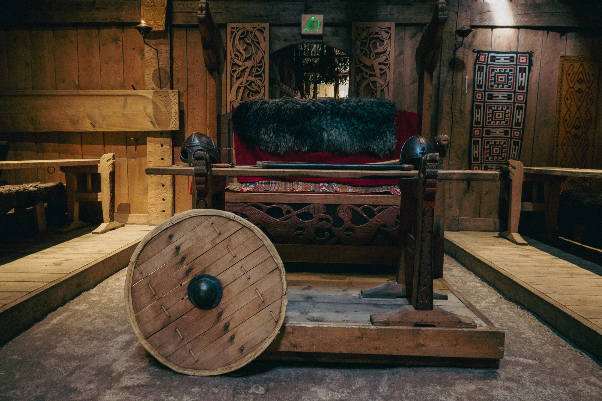 Traditional Viking leader's chair and shield on display in the Lofotr Viking Museum