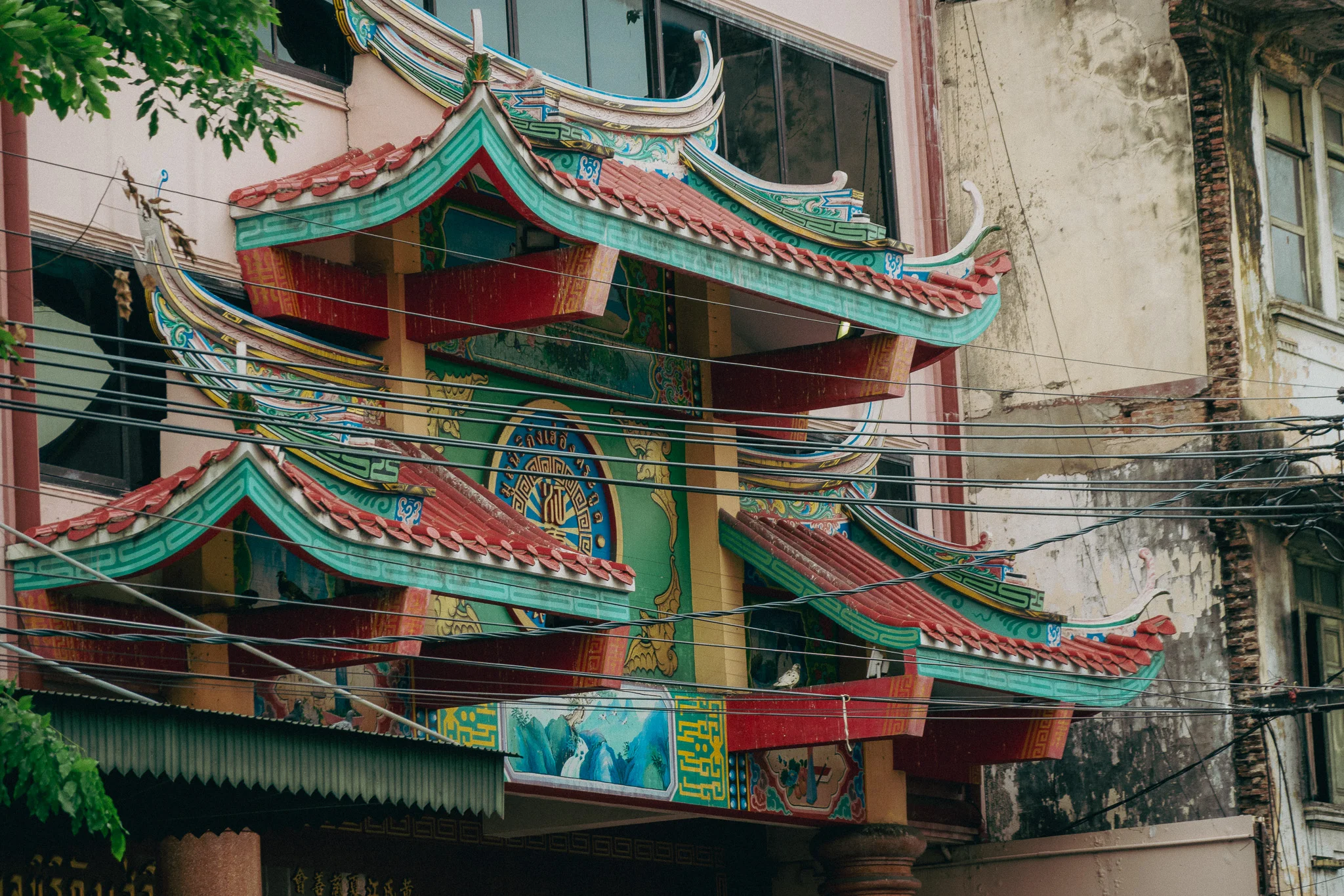 Traditional Thai architecture green and red archways.