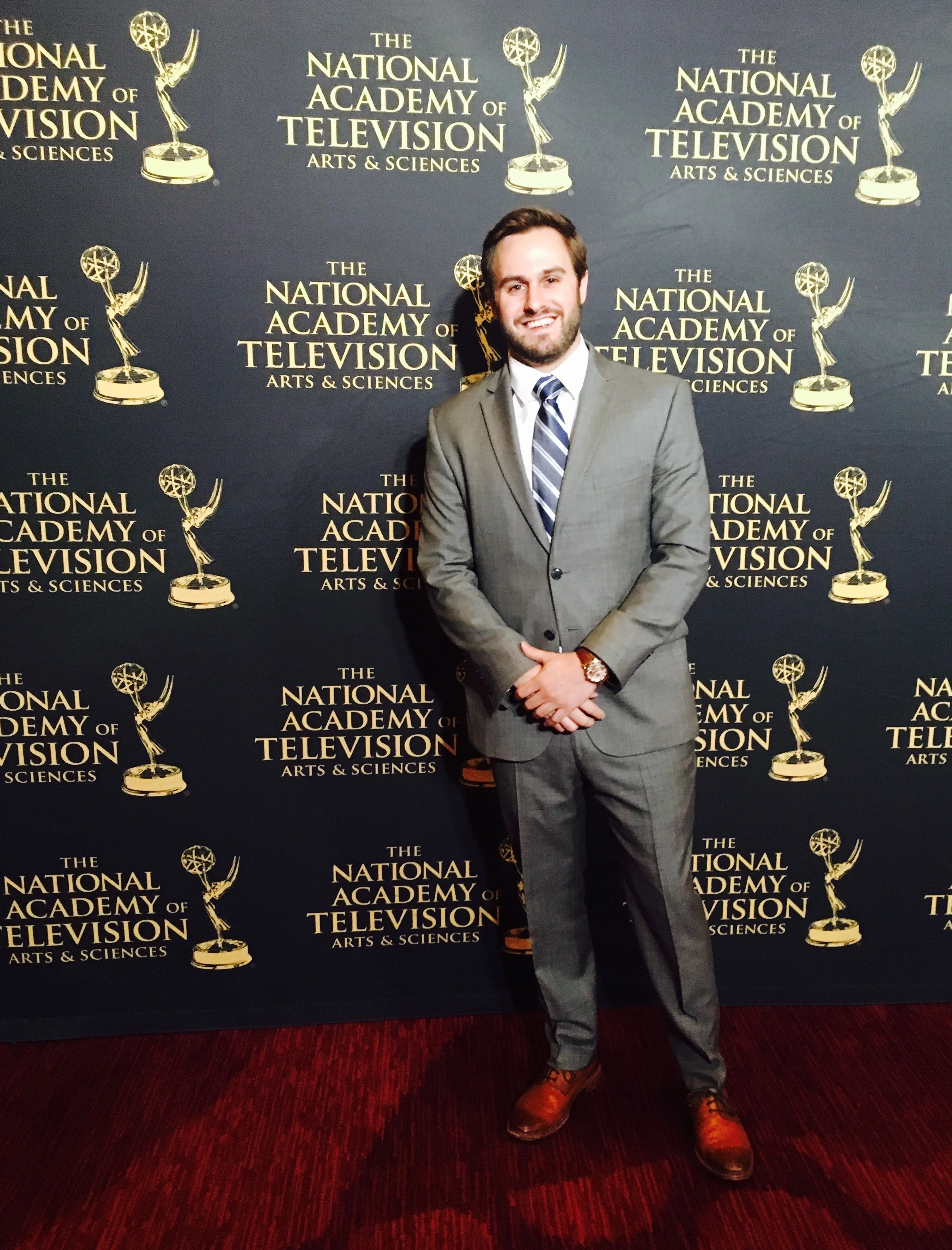 Doug Newton posing in front of a step and repeat at the NATAS Sports Emmys where he was nominated for outstanding motion graphic design
