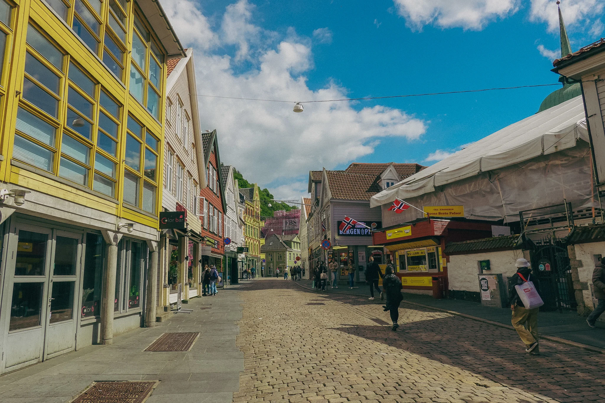 A vibrant city street with blue sky in the distance in Bergen Norway