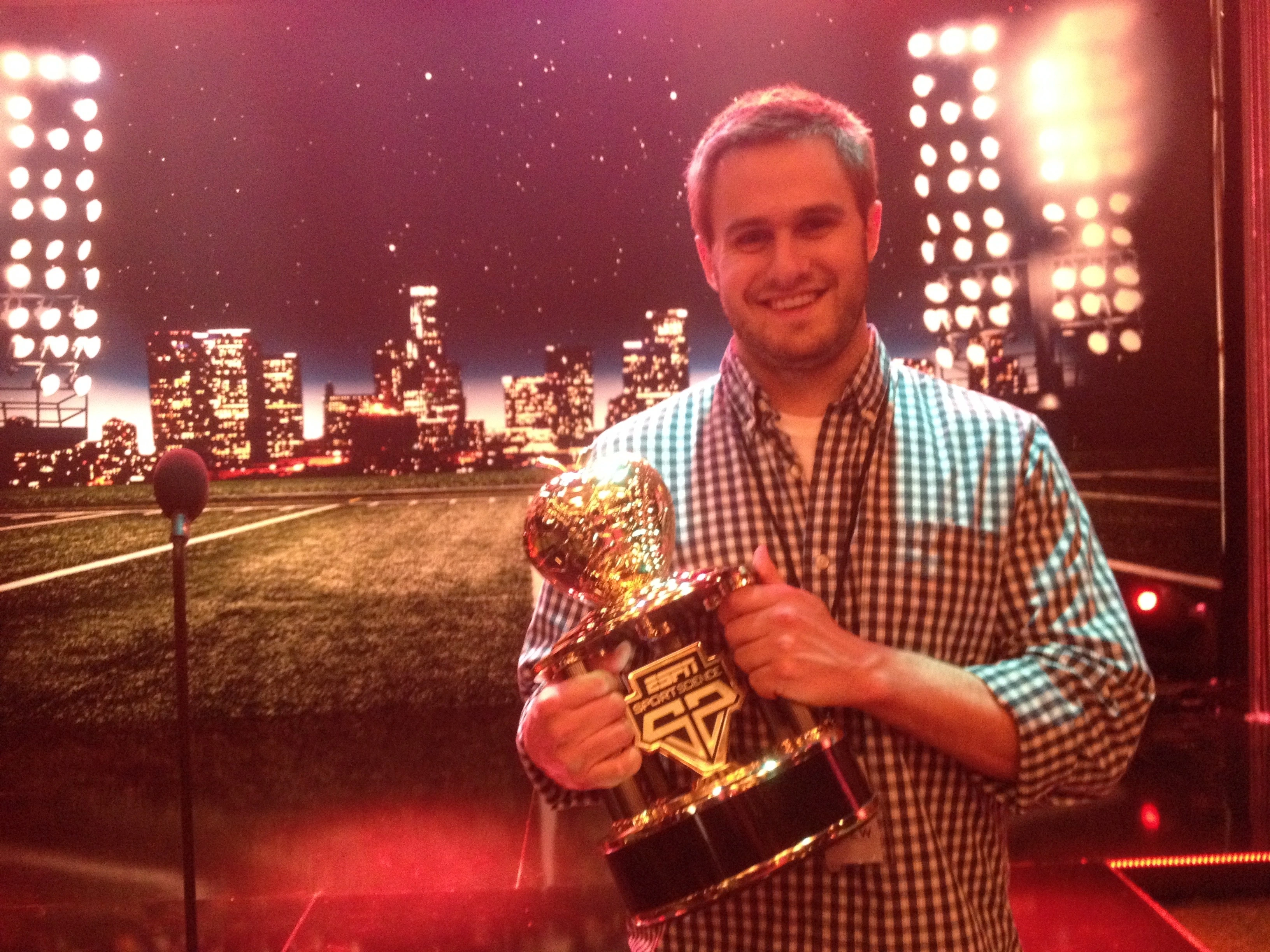 Doug Newton posing with the ESPN Sport Science Newton Award trophy he designed