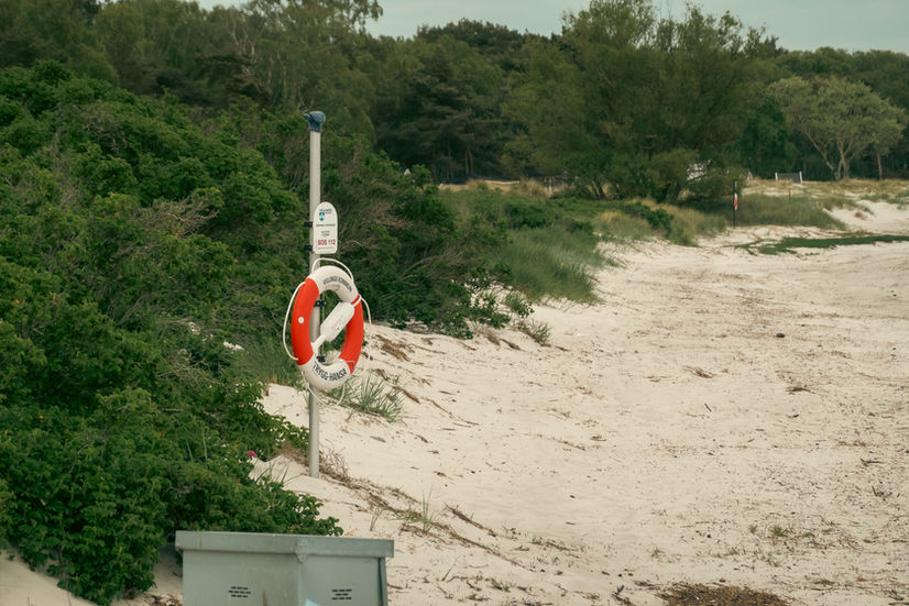 A red and white lifesaver on the Höllviken beach in Sweden