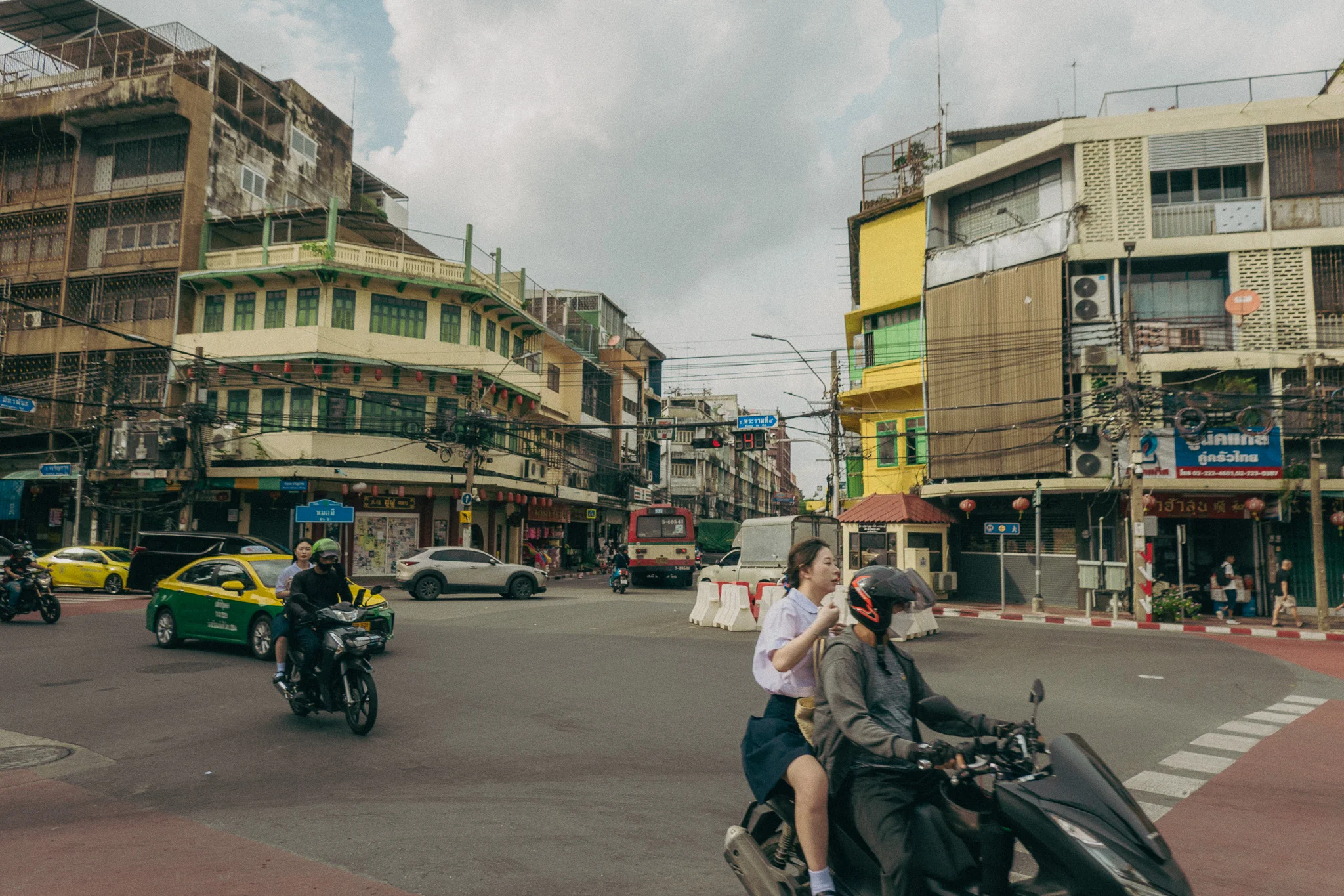 Moped drivers in the middle of an intersection in Bangkok Thailand