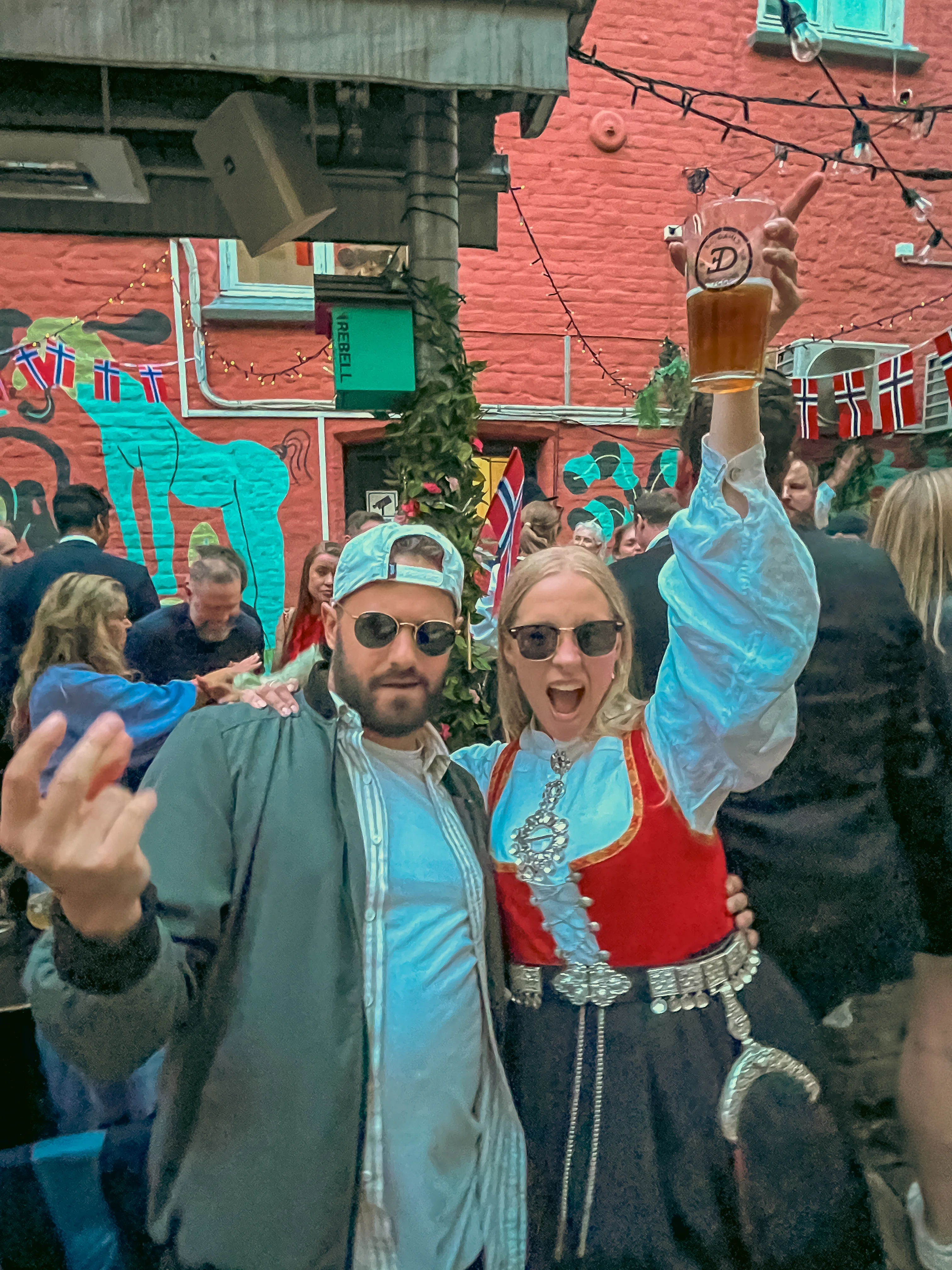 Doug and a girl in a traditional Norwegian budan posing for a picture on the back patio of Rebell bar celebrating Constitution Day in Oslo, Norway