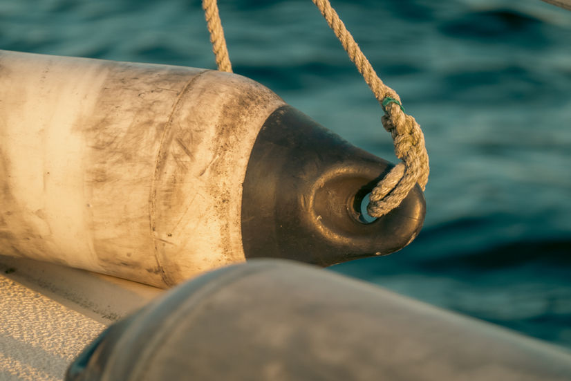A close up of a boat bumper on a sailboat at sunset in Malmo Sweden
