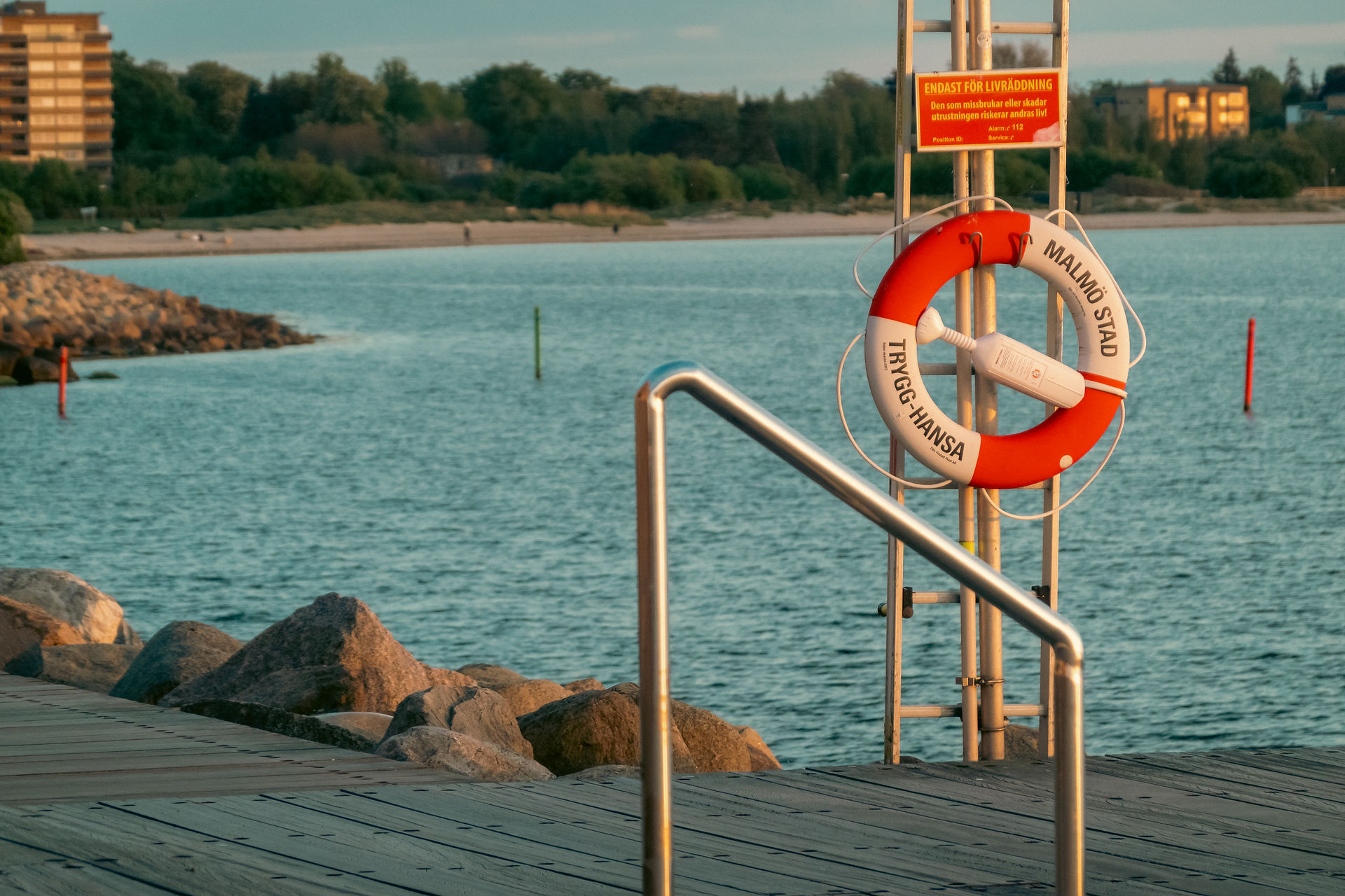 Wide shot of a life saver along the water in Malmo Sweden