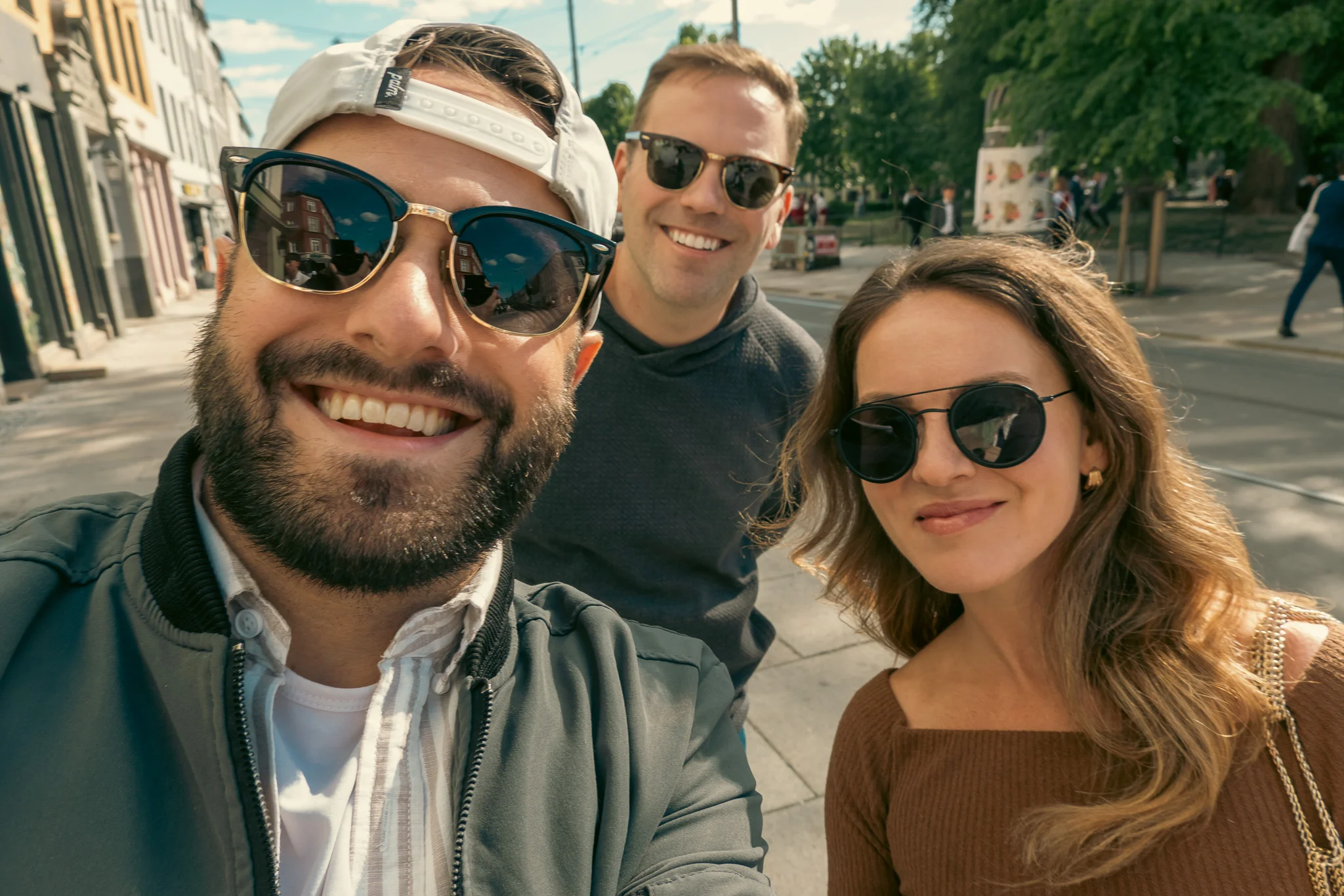 Doug, Kelly, and Hunter posing for a selfie on the streets of Oslo, Norway celebrating Constitution Day on May 17th 2025.