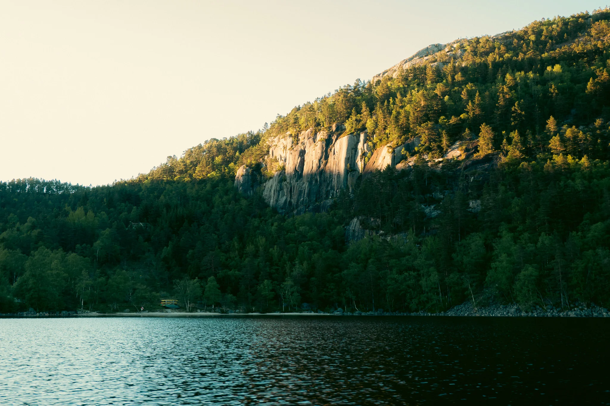 A shadow cast along a mountain on a lake in Norway.
