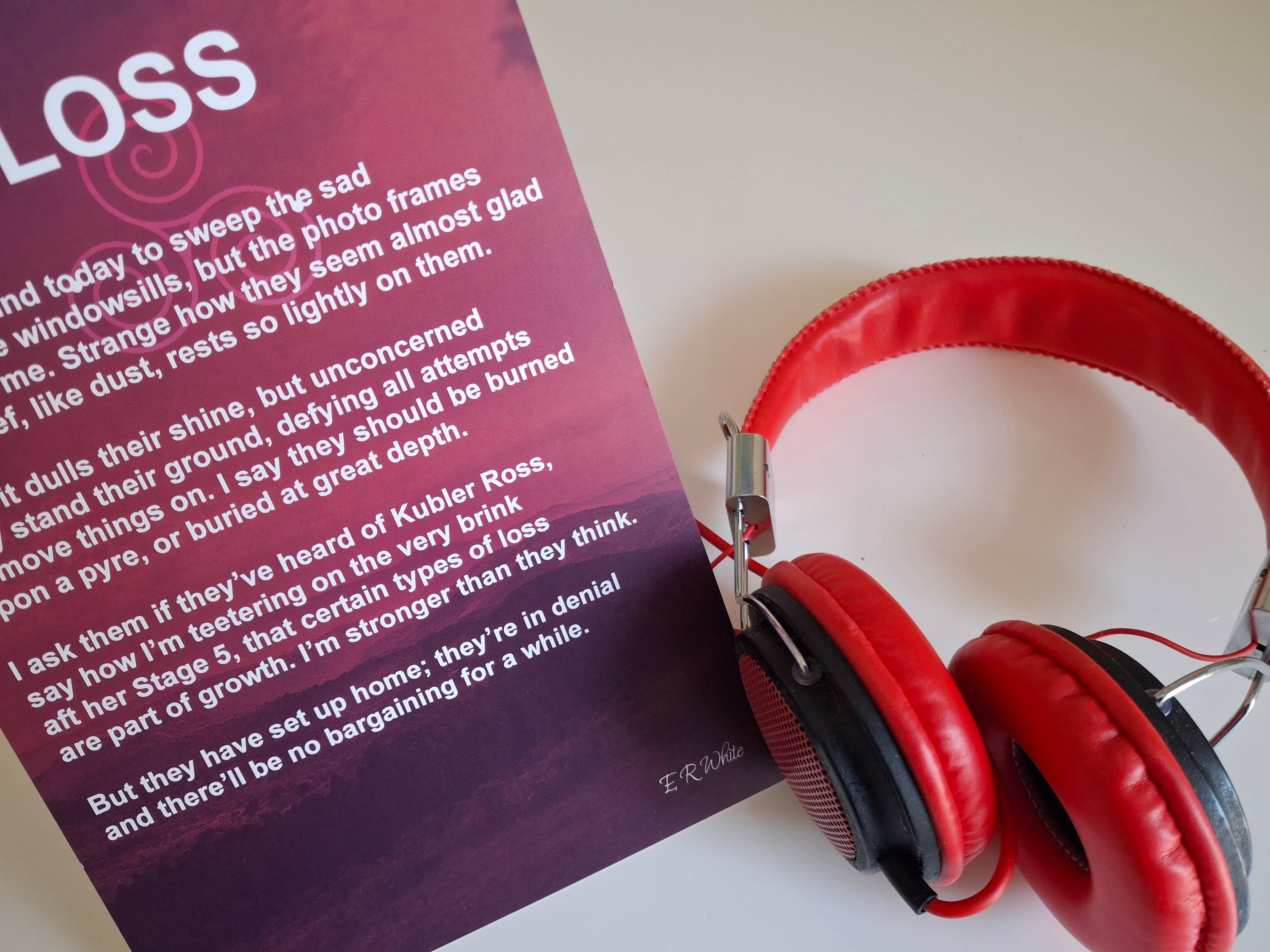 Image. Large print card and headphones.