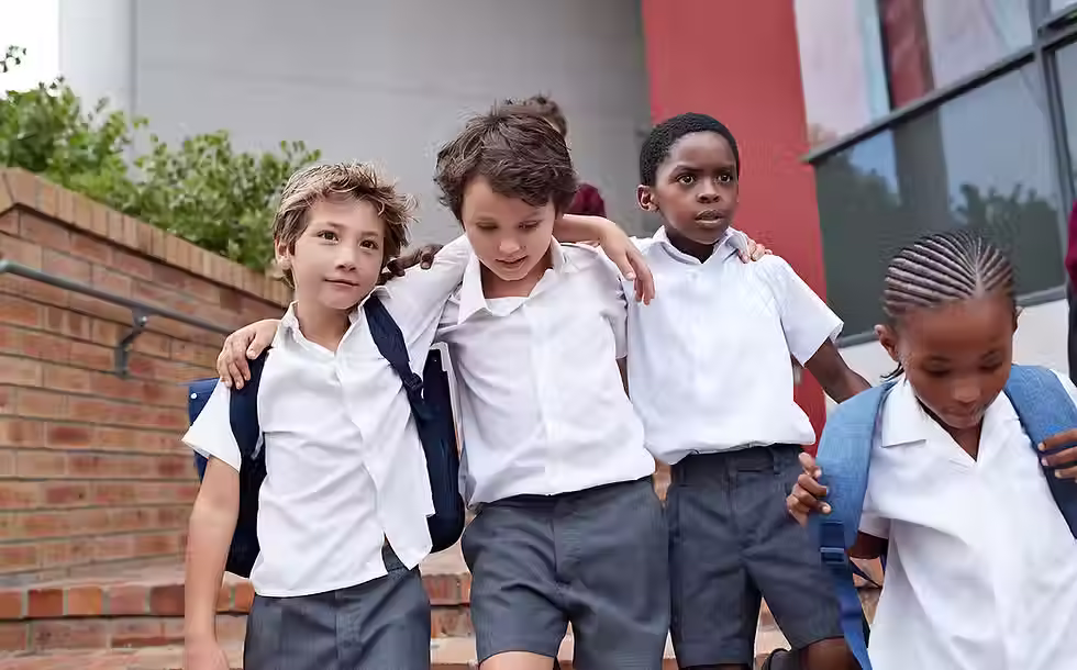 Three young boys stroll along the school path, showcasing friendship and camaraderie at school.