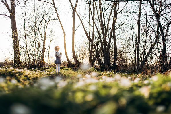 small-girl-stands-near-trees.jpg