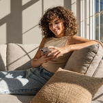 Woman on phone accessing Forma Wellness