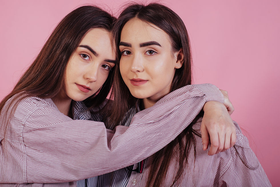 harmony-with-each-other-two-sisters-twins-standing-posing-studio-with-white-background.jpg