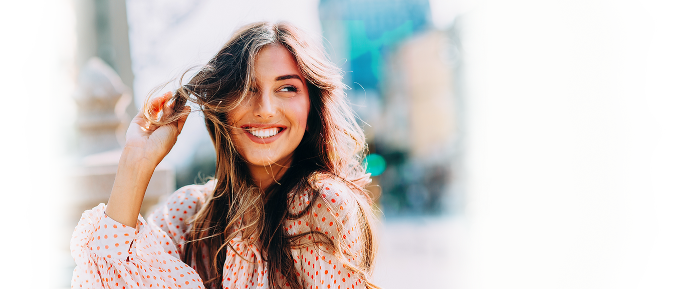 Beautiful woman smiling in polka-dot blouse