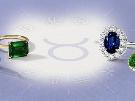 Emerald and sapphire jewelry placed on a Taurus zodiac chart.