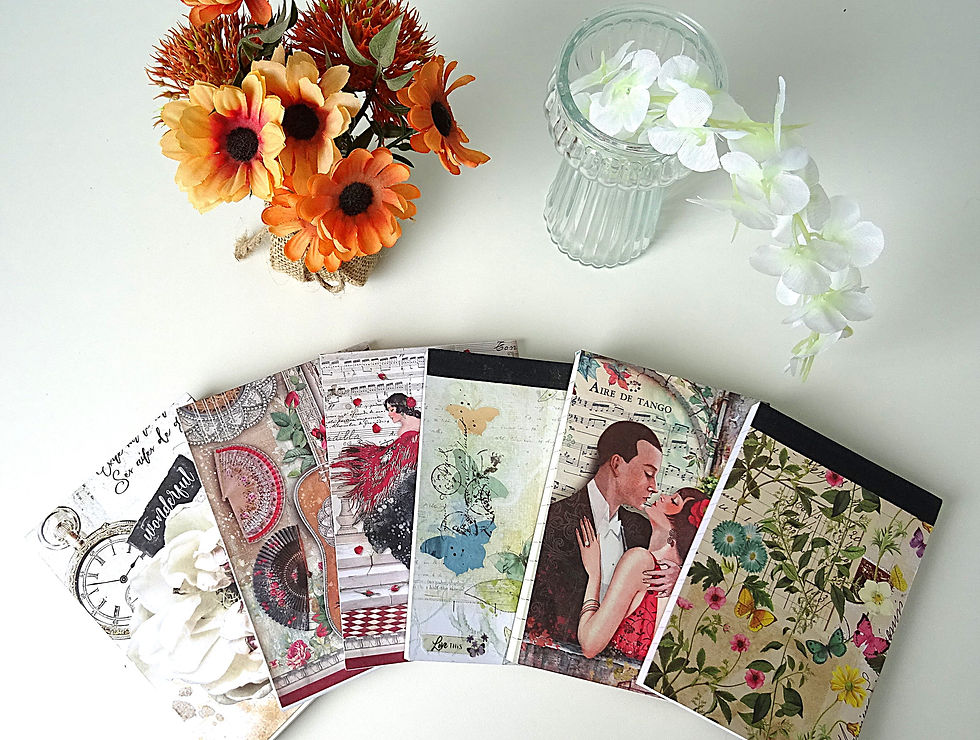 A6 notepads in various designs laid out on desk in fan style