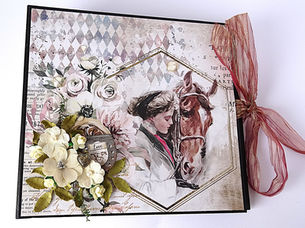 Front cover of album featuring woman with horse and 3d flower embellishments and ribbon closure.