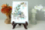 green and teal blue leaves with bird nestled among them, butterfly in top right with Heart & Soul message