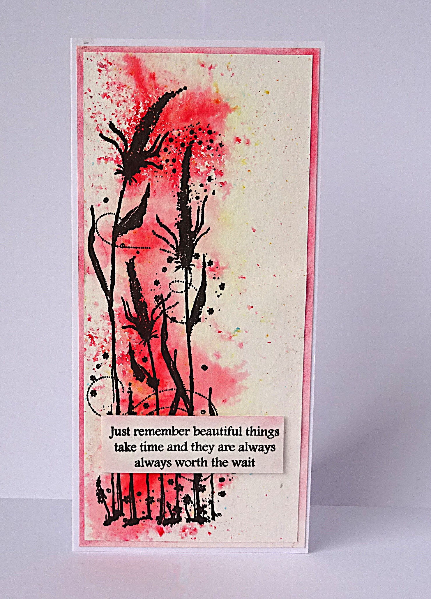red watercolour background; wildflowers; red trim around edge; inspirational quote
