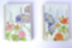 Two watercolour paintings covering notebooks: one with a field of blue and purple flowers, another with pink and red roses