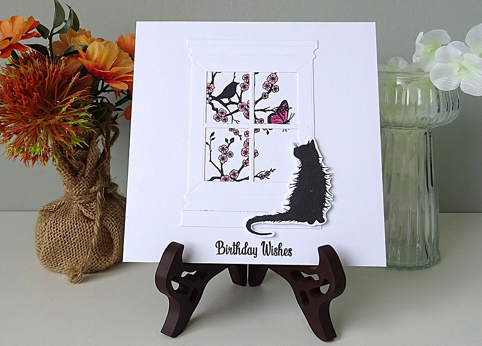 square white card; window with view of bird on cherry blossom tree with cat sitting on window sill watching bird