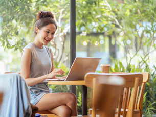 Digital nomad millennial gen x lifestyleasian female freelance casual working from cafe working anywhere work while vacation smiling hand type laptop cheerful positive thinking work remotely in cafe