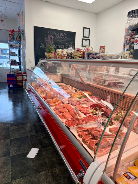British Bangers Company shop in Okotoks with handmade English sausages and holiday treats on display.