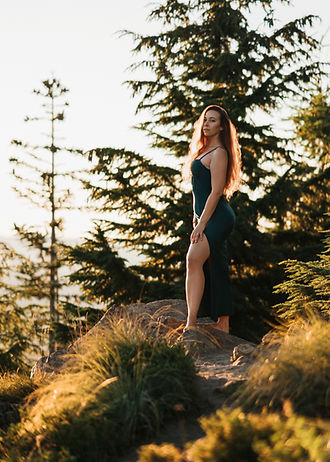 Sarah Layton standing on a cliff in the forest