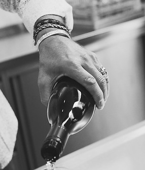 a person pours wine into a wine glass_ed